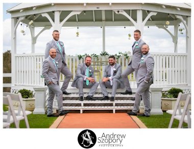 formal portrait photo of groom and groomsmen outside in gazebo