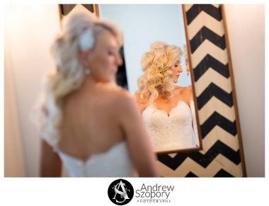 formal window lit portraits of bride reflection of her in a mirror shot from behind