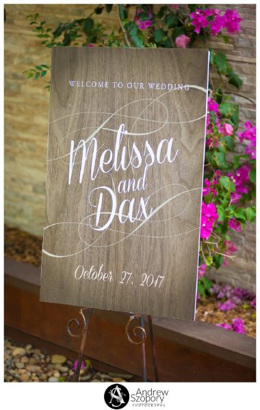 sign showing bride and grooms names and date outside ceremony