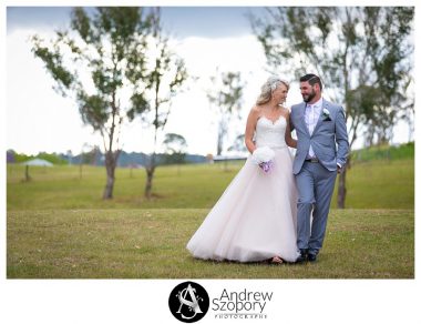 Bride and groom walking in open field at Mulgoa Valley receptions