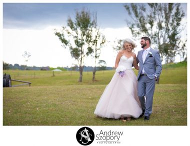 Bride and groom walking in open field at Mulgoa Valley receptions
