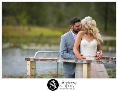 bride and groom stand on a jetty about to kiss