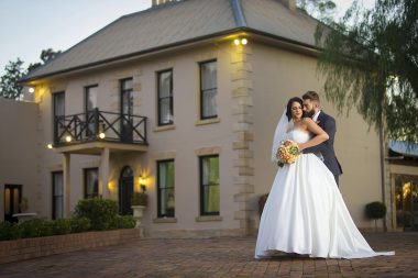 Bride and groom outside Eschol Park House at dusk