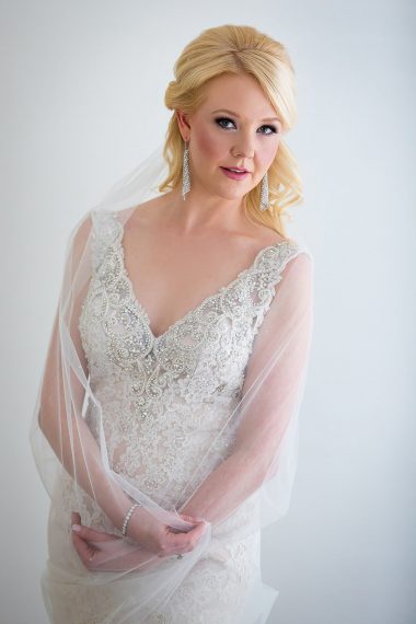 bridal-portrait-in-window-light holding veil