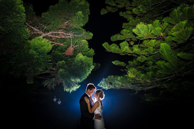wollongong wedding photographers couple kiss at night under trees at iconic wollongong venue